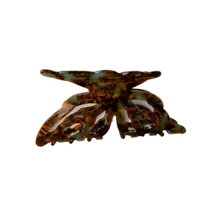 Butterfly-shaped acetate hair claw clip with tortoise shell pattern in brown and blue colors