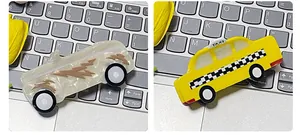 Detail view of cartoon car hair claws featuring a yellow taxi and marble lightning patterns