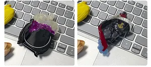 Detailed shot of cauldron and ship-shaped acrylic hair claws on a laptop keyboard