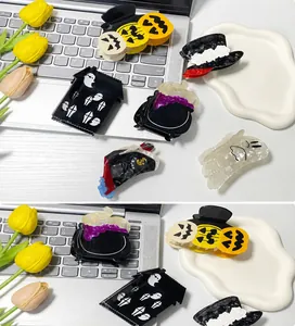 Detailed shot of Halloween acetate hair claws featuring pumpkin and ghost designs