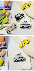 Detail shot of creative acetate hair claws in various cartoon police car and taxi designs