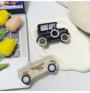 Detail of creative car-shaped acetate hair claws including vintage car and race car designs