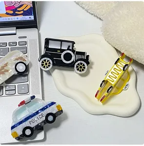 Detail of car-shaped acetate hair claws including police car and taxi designs