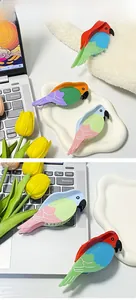 Vue détaillée de pinces à cheveux colorées en forme de perroquet avec motifs créatifs