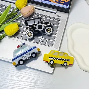 Creative police car and taxi acetate hair claw clips for women set on a silver laptop
