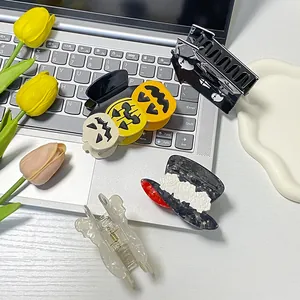 Halloween pumpkin ghost and bat hair clips set on laptop with decorative tulips