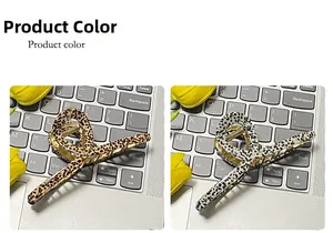 Detailed comparison of brown and white leopard print acetate claw clips on keyboard