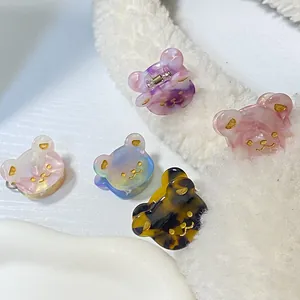 Fünf Mini-Haarklammern aus Acetat-Bär mit schillernden Marmormustern und Goldakzenten