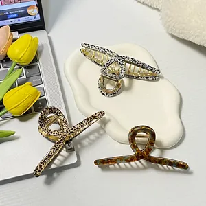 Three premium acetate claw clips in marble, leopard, and amber patterns for thick hair