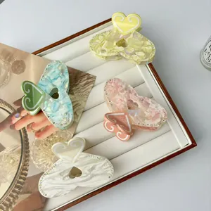 Chic heart-shaped acetate claw clips with rhinestones in four pastel jelly colors
