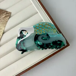 Creative mermaid style hair claw clip with dark green marble texture and gold fish scales