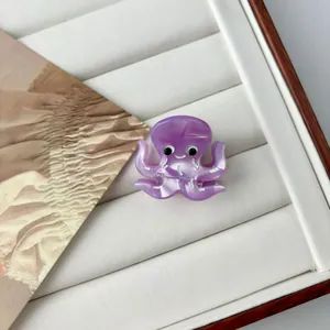 Detail of a mini octopus hair claw clip in purple acetate with pearl luster