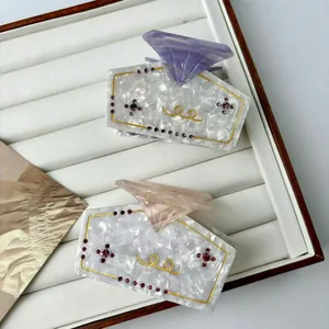 Elegante Haarklammern aus Celluloseacetat mit Strasssteinen in Lila- und Rosatönen