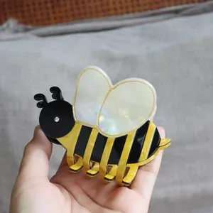Cute bumblebee hair claw clip featuring yellow black stripes and iridescent wings
