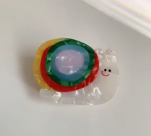 Detail of colorful acetate snail hair clip with pearl texture and vibrant multi-color spiral