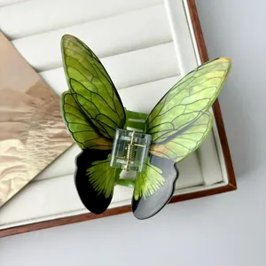 Elegant translucent green butterfly hair claw clip with golden metal spring for women
