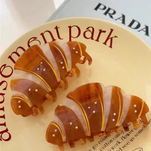 French croissant hair claw clips with rhinestones in amber and cream resin