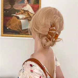 French croissant hair claw clip with diamonds on blonde hair for elegant styling
