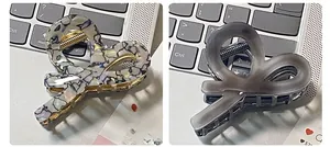 Detail of elegant acetate hair claws in iridescent shell and translucent grey finishes