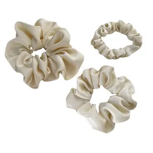 Three-piece set of cream satin scrunchies in small, medium, and large sizes