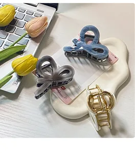 Detailed top view of acetate claw clips in blue, grey, and cream with tulip decor
