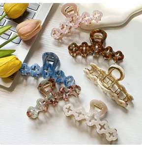 Detailed set of six floral hair claws in various patterns on a laptop background