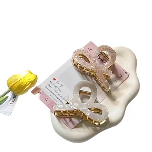 Set of two elegant acetate hair claws in pink and ivory with pearlized marble finish