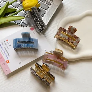 Set of 5 square claw clips in marbled acetate finishes shown in a lifestyle scene