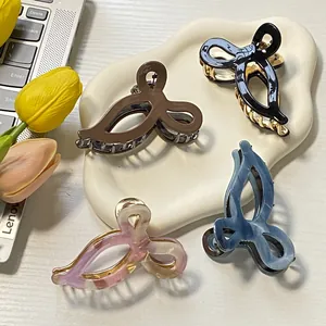 Set of four hollow butterfly hair claws in acetate and metal on a ceramic tray