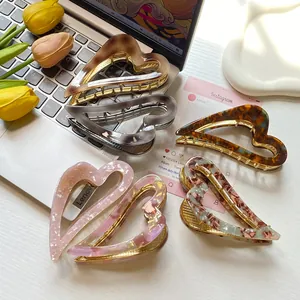 Elegant heart-shaped acetate hair claw clips in various marble and tortoiseshell patterns