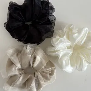 Three-piece mesh scrunchie set in black, ivory, and champagne with elegant pleats