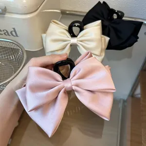 Large satin double-layered bow hair claw clip in elegant pink for versatile hair styling