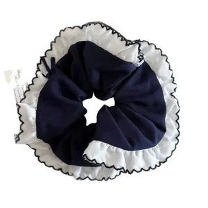 Navy blue oversized hair scrunchie with layered white lace ruffles and black edge stitching