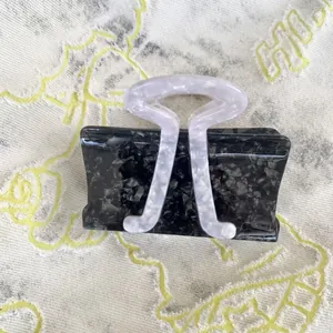 Unique sunfish shape hair claw clip with black and white marble acetate texture for women