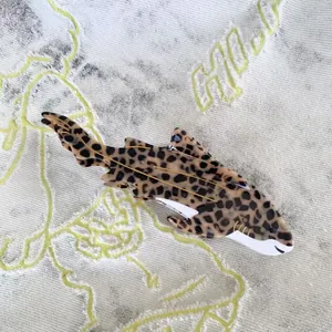 Detailed view of leopard shark hair claw clip with acetate texture and gold wire inlay