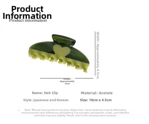 Detail view of acetate shark hair claw in dark green and beige heart with 10cm size label