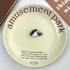 Close-up of black and white acetate shark hair claw clip on a decorative tray