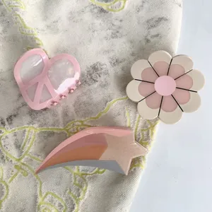 Acetate hair claw clip set featuring heart, flower, and star shapes in pink and cream