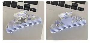 Detail of marble pattern acetate hair claws with star and heart hollow decorations