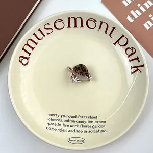 Detail of tortoise shell acetate hair claw clip in cute sea turtle shape on ceramic plate