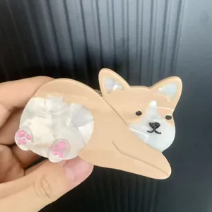 Cute corgi dog acetate hair claw clip with glossy finish and pink paw detail in hand