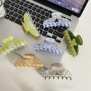 French style vintage acetate hair claw clips set in various colors on a laptop desk