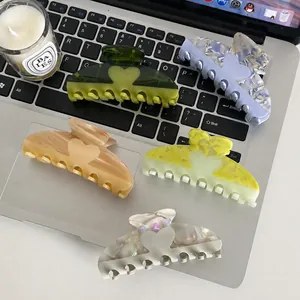 Five-piece acetate hair claw clips with marble texture and heart cutout design