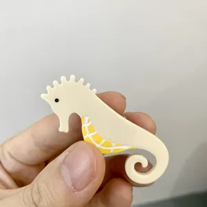 Pince à cheveux fantaisie en forme d'hippocampe en acétate crème et jaune