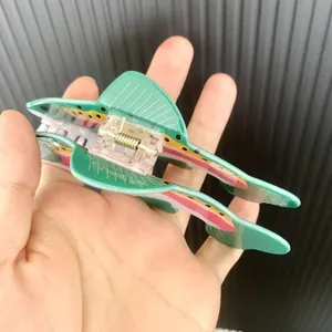 Creative fish-shaped hair claw clip in green acetate with pink stripes and metal spring