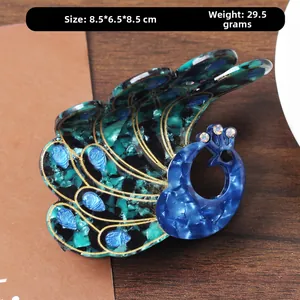 Detailed macro view of peacock acetate claw clip with sparkling rhinestones and gold edges