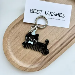 Macro detail of cartoon black cat hair comb keychain made of marbled acetate fiber