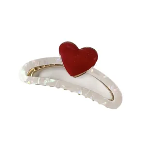 Iridescent white hair claw clip with vibrant red heart accent for elegant styling