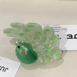 Elegant peacock shaped acetate hair claw clip with crystal accents and gold detailing