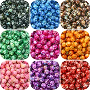 Macro detail of multi-colored acrylic beads with marble texture and holes for DIY jewelry